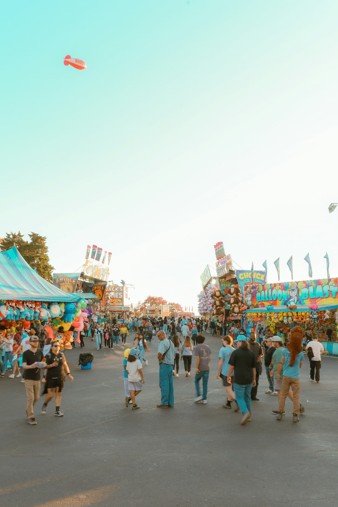 Crowd enjoying the midway at a fall carnival
